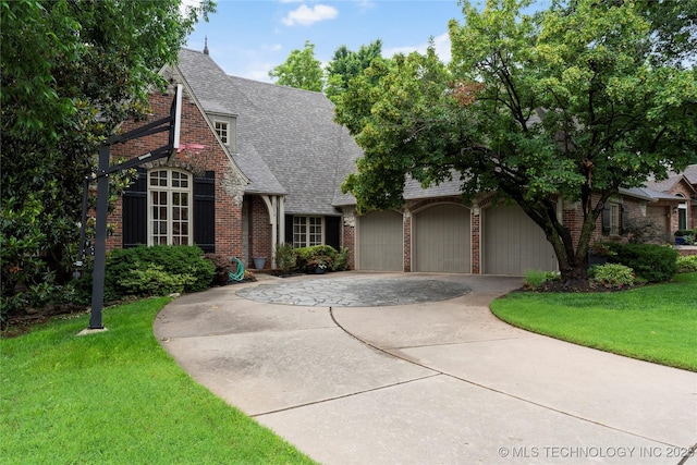 9034 S Maplewood Ave, Tulsa, OK 74137 - view of front of home with brick siding, a shingled roof, driveway, a front yard, and a garage