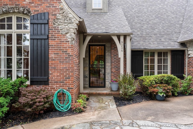 9034 S Maplewood Ave, Tulsa, OK 74137 - view of exterior entry with brick siding and a shingled roof