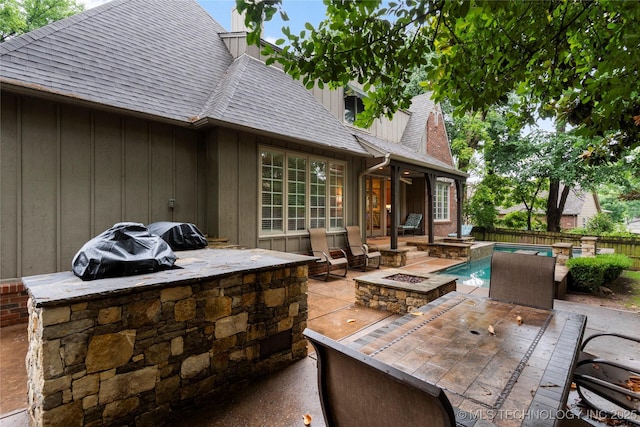 9034 S Maplewood Ave, Tulsa, OK 74137 - view of patio / terrace with a fire pit and an outdoor kitchen