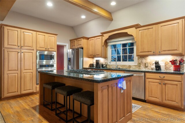 9034 S Maplewood Ave, Tulsa, OK 74137 - kitchen featuring appliances with stainless steel finishes, backsplash, light wood-style floors, a kitchen bar, and beam ceiling