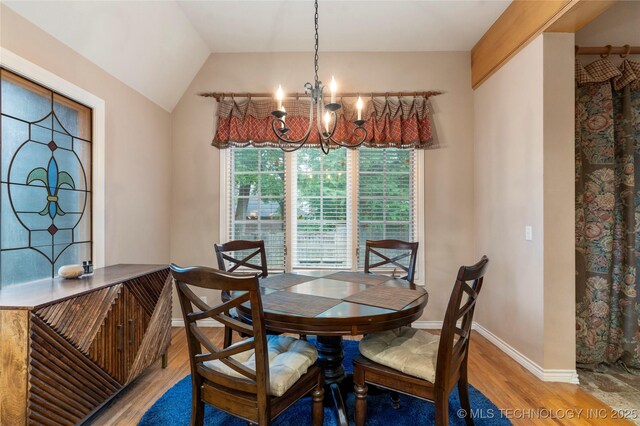 9034 S Maplewood Ave, Tulsa, OK 74137 - dining space featuring a chandelier, wood finished floors, and lofted ceiling