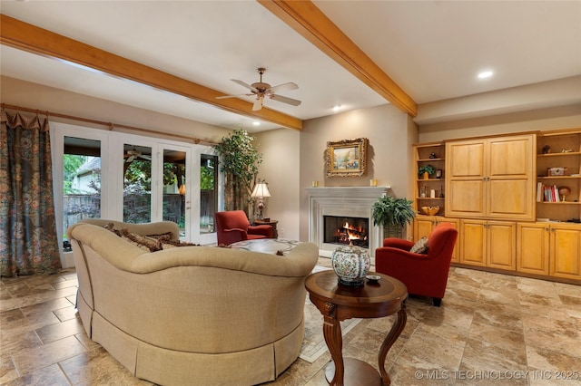 9034 S Maplewood Ave, Tulsa, OK 74137 - living room with beam ceiling, stone tile floors, ceiling fan, a lit fireplace, and recessed lighting