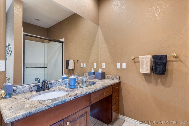 9034 S Maplewood Ave, Tulsa, OK 74137 - bathroom with vanity, a shower with shower door, and tile patterned flooring