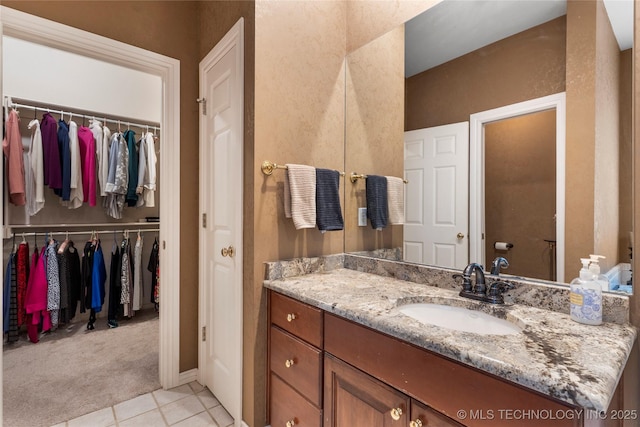 9034 S Maplewood Ave, Tulsa, OK 74137 - bathroom featuring vanity, tile patterned floors, and a spacious closet