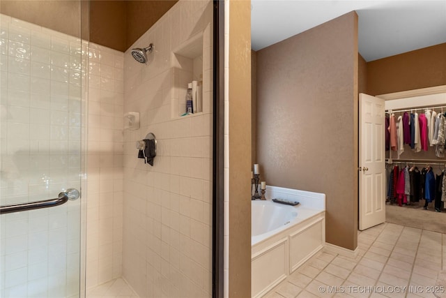 9034 S Maplewood Ave, Tulsa, OK 74137 - full bathroom with a stall shower, a bath, tile patterned floors, and a walk in closet