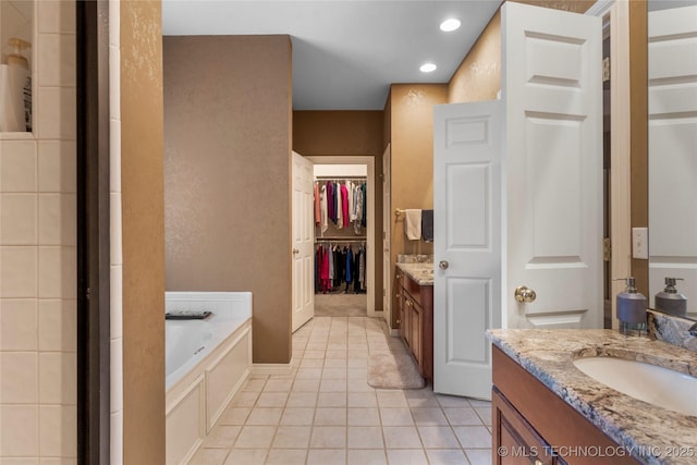 9034 S Maplewood Ave, Tulsa, OK 74137 - full bath with vanity, a bath, tile patterned flooring, a spacious closet, and recessed lighting