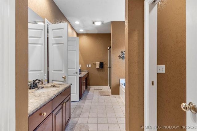 9034 S Maplewood Ave, Tulsa, OK 74137 - bathroom with a stall shower, vanity, tile patterned floors, a garden tub, and recessed lighting