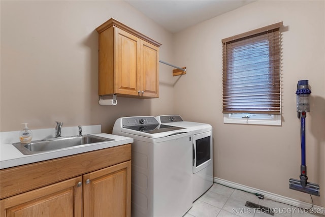 9034 S Maplewood Ave, Tulsa, OK 74137 - laundry room with separate washer and dryer, cabinet space, and light tile patterned floors