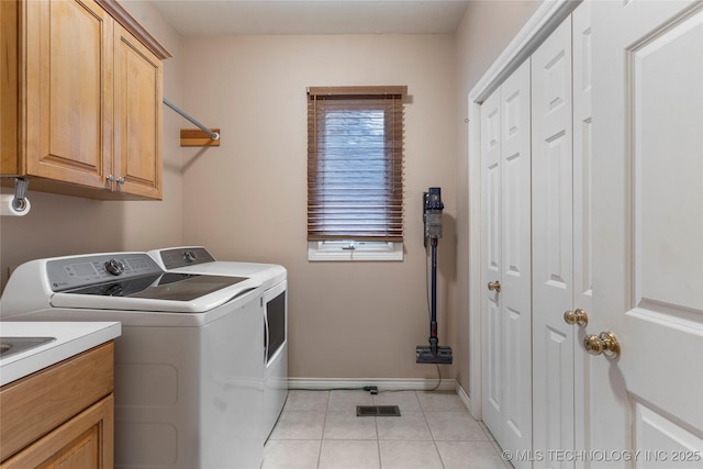 9034 S Maplewood Ave, Tulsa, OK 74137 - laundry area featuring independent washer and dryer, cabinet space, and light tile patterned floors