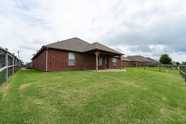 18312 E 46th St, Tulsa, OK 74134 - rear view of house featuring a fenced backyard, brick siding, a patio area, and a shingled roof