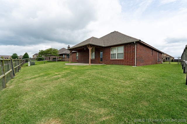 18312 E 46th St, Tulsa, OK 74134 - rear view of property featuring a fenced backyard, brick siding, a patio area, and roof with shingles