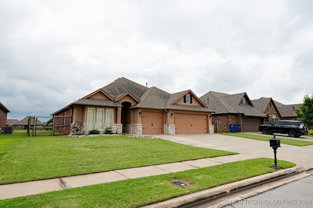 18312 E 46th St, Tulsa, OK 74134 - view of front of property with a garage, concrete driveway, a gate, stone siding, and a shingled roof