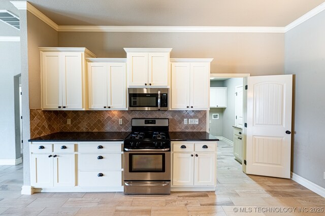 18312 E 46th St, Tulsa, OK 74134 - kitchen featuring stainless steel appliances, ornamental molding, dark countertops, backsplash, and white cabinets