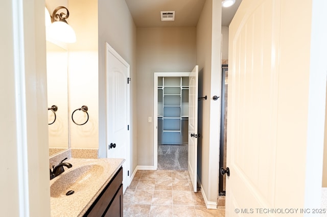 18312 E 46th St, Tulsa, OK 74134 - bathroom with vanity and a walk in closet
