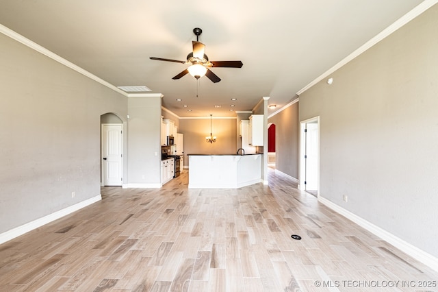 18312 E 46th St, Tulsa, OK 74134 - unfurnished living room featuring arched walkways, a ceiling fan, ornamental molding, light wood-style floors, and recessed lighting