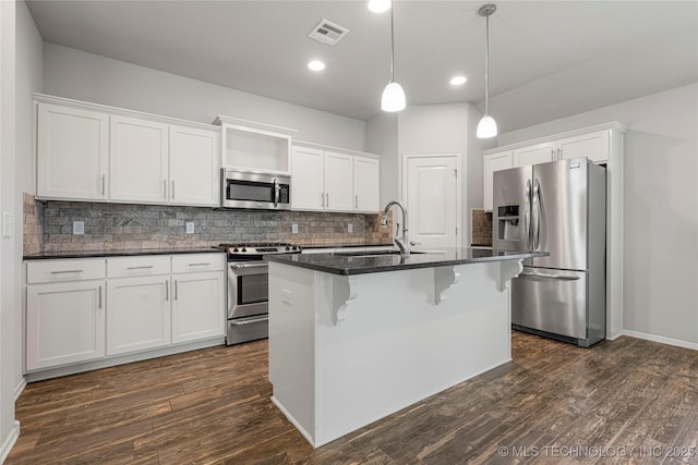 10387 S Nathan St, Jenks, OK 74037 - kitchen featuring appliances with stainless steel finishes, dark countertops, decorative backsplash, white cabinets, and recessed lighting