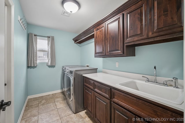 1620 E Boston Ct, Broken Arrow, OK 74012 - laundry room featuring cabinet space, washing machine and dryer, and light tile patterned flooring