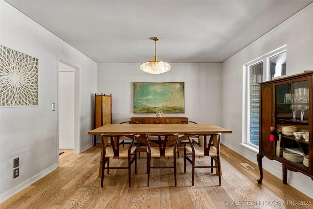 2962 E 56th Ct, Tulsa, OK 74105 - dining space with light wood-style flooring and a chandelier