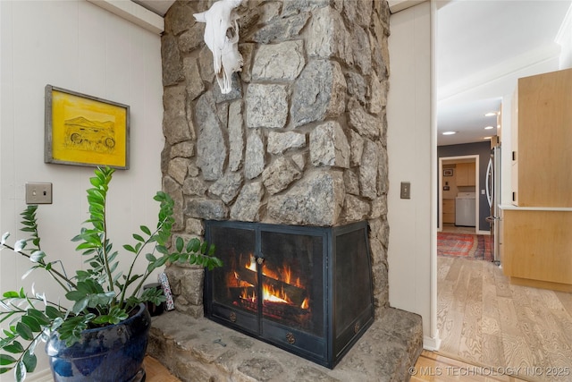 2962 E 56th Ct, Tulsa, OK 74105 - detailed view of wood finished floors, a stone fireplace, and freestanding refrigerator