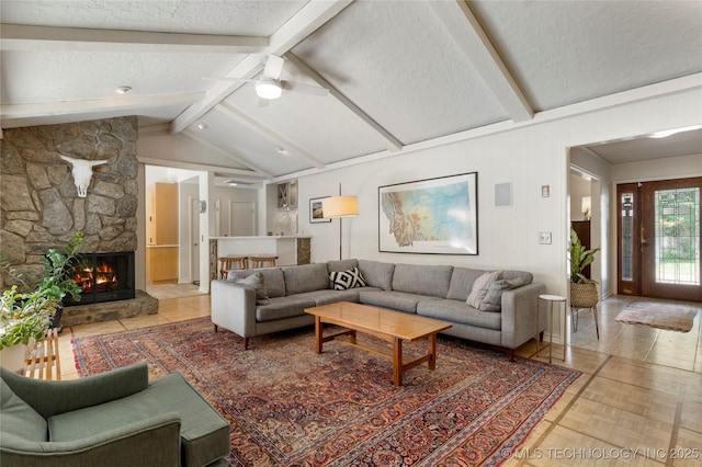 2962 E 56th Ct, Tulsa, OK 74105 - living area with a textured ceiling, a stone fireplace, and ceiling fan
