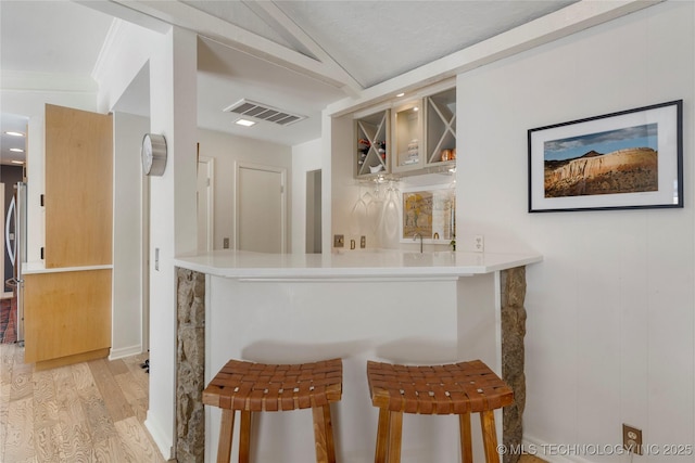 2962 E 56th Ct, Tulsa, OK 74105 - indoor bar with light wood-type flooring, lofted ceiling, and freestanding refrigerator