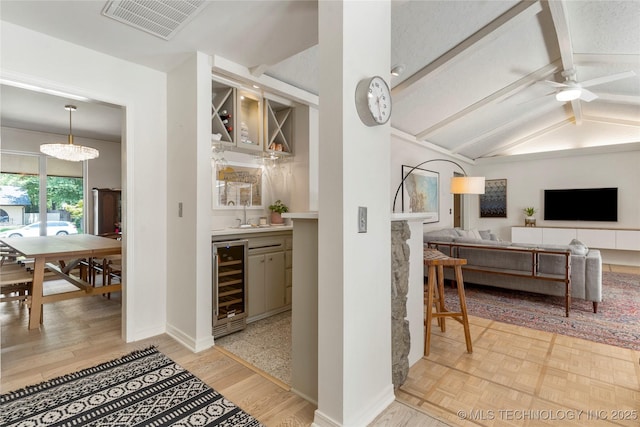 2962 E 56th Ct, Tulsa, OK 74105 - indoor wet bar featuring beverage cooler, a ceiling fan, and wood finished floors