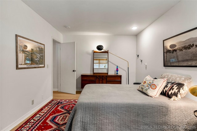 2962 E 56th Ct, Tulsa, OK 74105 - bedroom featuring baseboards and wood finished floors