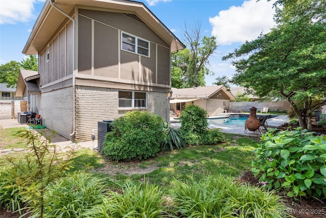 2962 E 56th Ct, Tulsa, OK 74105 - back of house featuring brick siding and a fenced backyard