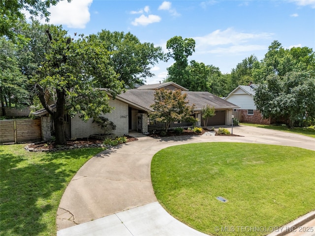 2962 E 56th Ct, Tulsa, OK 74105 - view of front facade with driveway, brick siding, and an attached garage