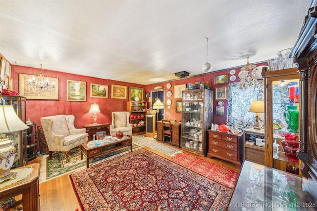 1608 E 56th St N, Tulsa, OK 74126 - living room with wood finished floors, a chandelier, and a textured ceiling