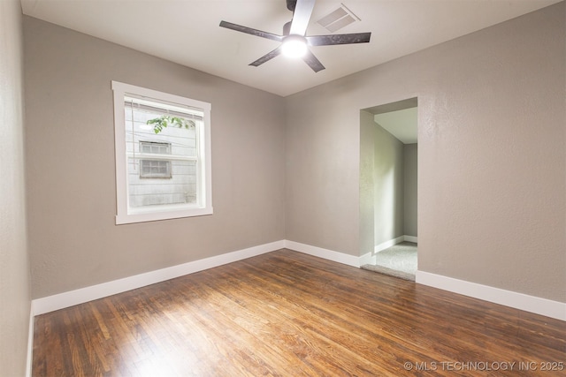 812 N Delaware Pl, Tulsa, OK 74110 - empty room with wood finished floors and a ceiling fan