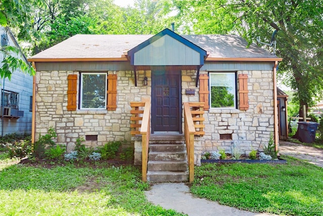 812 N Delaware Pl, Tulsa, OK 74110 - bungalow featuring stone siding and a shingled roof
