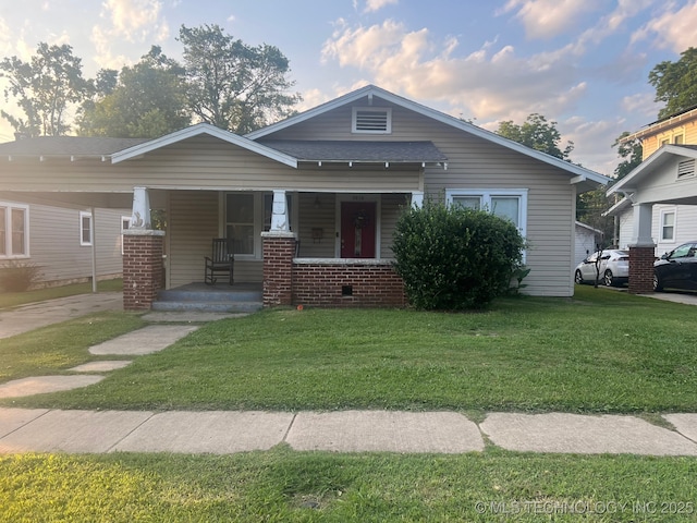 2820 W Okmulgee, Muskogee, OK 74401 - view of front facade featuring covered porch, a front yard, and an attached carport
