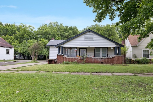 2820 W Okmulgee, Muskogee, OK 74401 - view of front of home featuring a front lawn, a porch, and concrete driveway