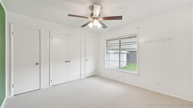 702 E Elgin Pl, Broken Arrow, OK 74012 - unfurnished bedroom featuring carpet, a closet, a textured ceiling, and a ceiling fan