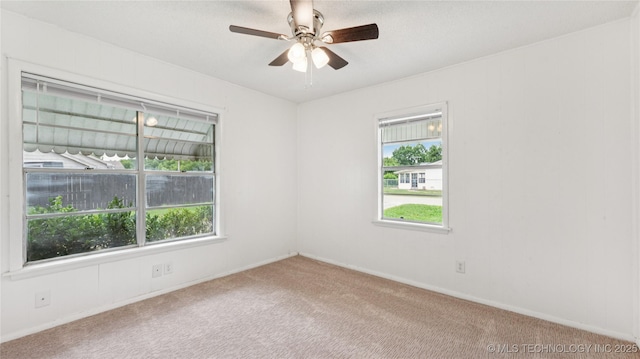 702 E Elgin Pl, Broken Arrow, OK 74012 - unfurnished room featuring plenty of natural light, carpet flooring, and a ceiling fan