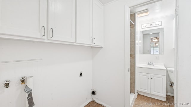 702 E Elgin Pl, Broken Arrow, OK 74012 - washroom with hookup for an electric dryer, cabinet space, and light tile patterned floors