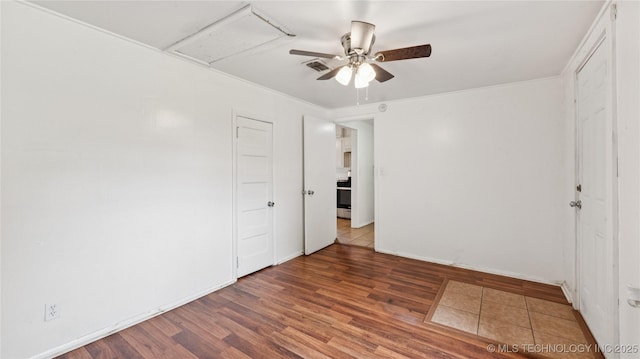 702 E Elgin Pl, Broken Arrow, OK 74012 - unfurnished room featuring a ceiling fan and wood finished floors