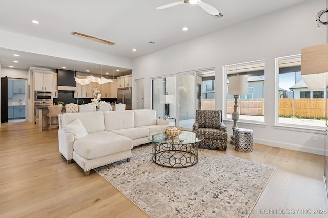 12622 S Granite Ave E, Bixby, OK 74008 - living area with light wood-style floors, a ceiling fan, and recessed lighting