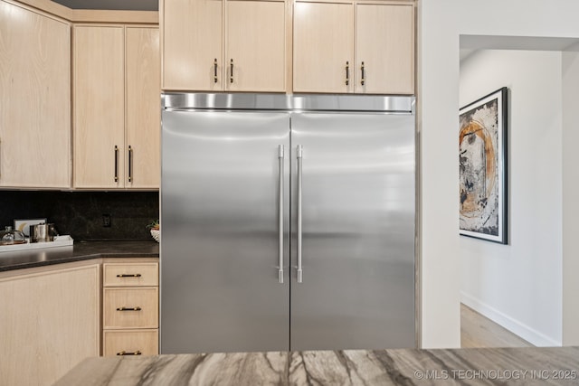 12622 S Granite Ave E, Bixby, OK 74008 - kitchen with stainless steel built in refrigerator, light brown cabinets, decorative backsplash, wood finished floors, and dark countertops