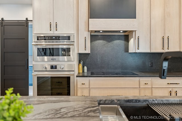 12622 S Granite Ave E, Bixby, OK 74008 - kitchen with custom range hood, black electric cooktop, stainless steel double oven, backsplash, and dark stone counters