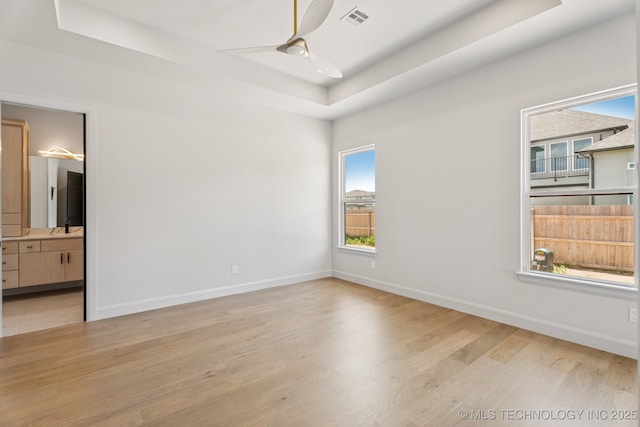 12622 S Granite Ave E, Bixby, OK 74008 - unfurnished room featuring a tray ceiling, ceiling fan, and wood finished floors