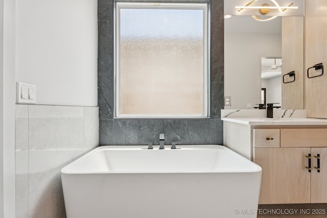 12622 S Granite Ave E, Bixby, OK 74008 - full bath featuring a freestanding tub, vanity, and tile walls