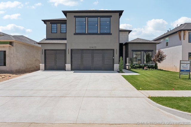 12622 S Granite Ave E, Bixby, OK 74008 - contemporary house with an attached garage, stucco siding, driveway, and a front yard
