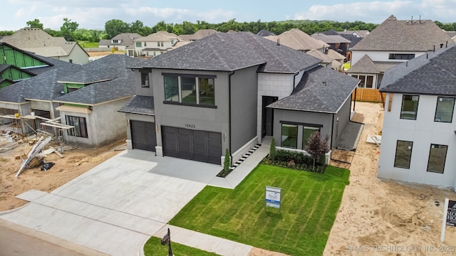 12622 S Granite Ave E, Bixby, OK 74008 - view of front of property featuring a residential view, driveway, stucco siding, roof with shingles, and an attached garage