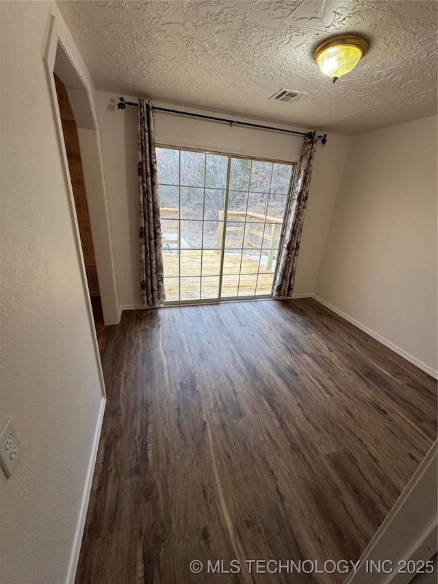 14274 W Clyde Maher, Tahlequah, OK 74464 - empty room featuring dark wood-type flooring and a textured ceiling