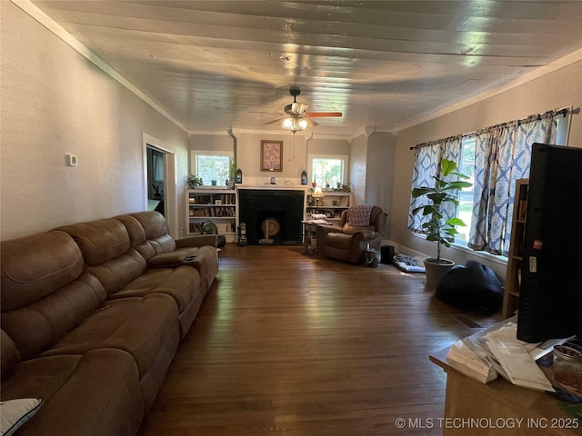 307 NE A St, Antlers, OK 74523 - living room with dark wood-type flooring, ceiling fan, ornamental molding, and a fireplace