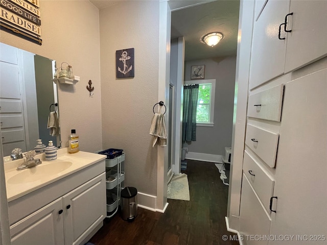 307 NE A St, Antlers, OK 74523 - bathroom featuring vanity and wood finished floors