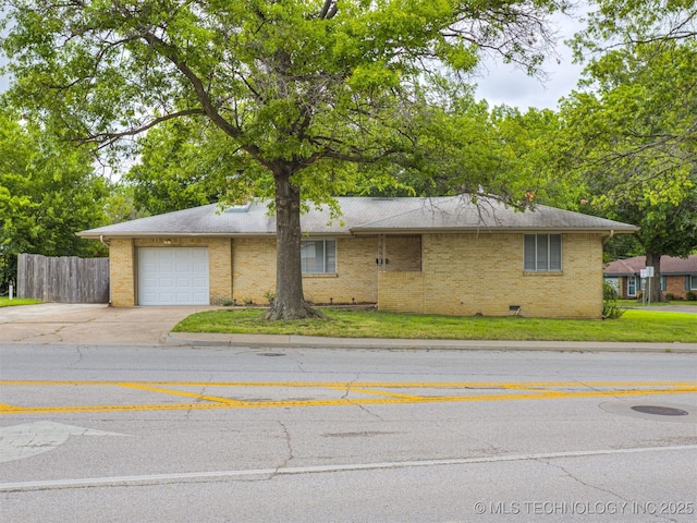 4512 SE Frank Phillips Blvd, Bartlesville, OK 74006 - view of front of home featuring driveway, an attached garage, and brick siding