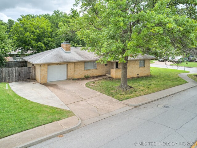 4512 SE Frank Phillips Blvd, Bartlesville, OK 74006 - ranch-style house featuring concrete driveway, brick siding, an attached garage, and a chimney